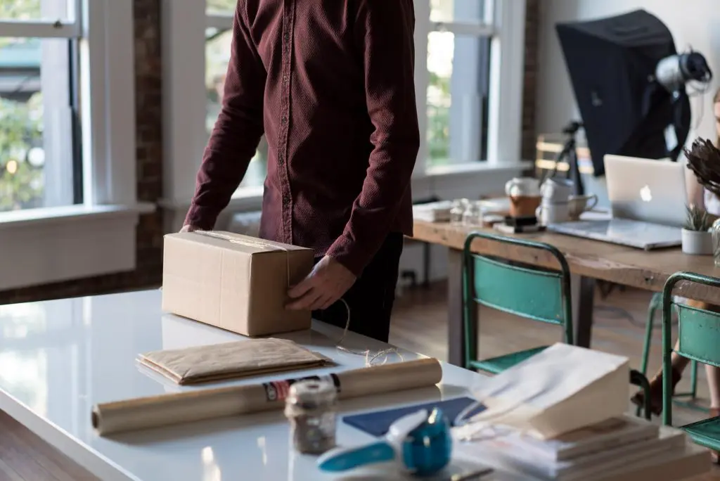 Man wrapping cardboard box