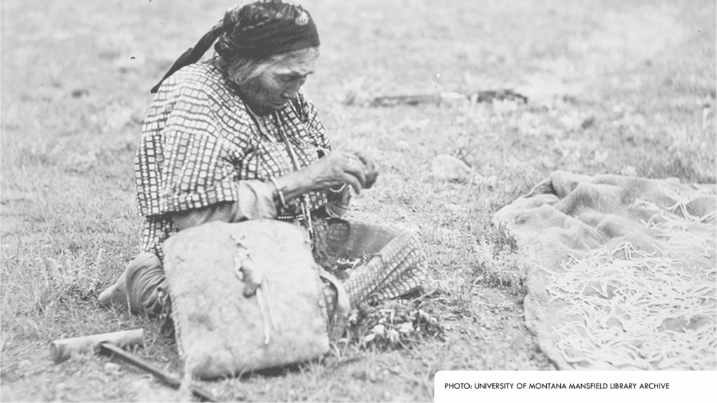 First Nations person sitting on ground
