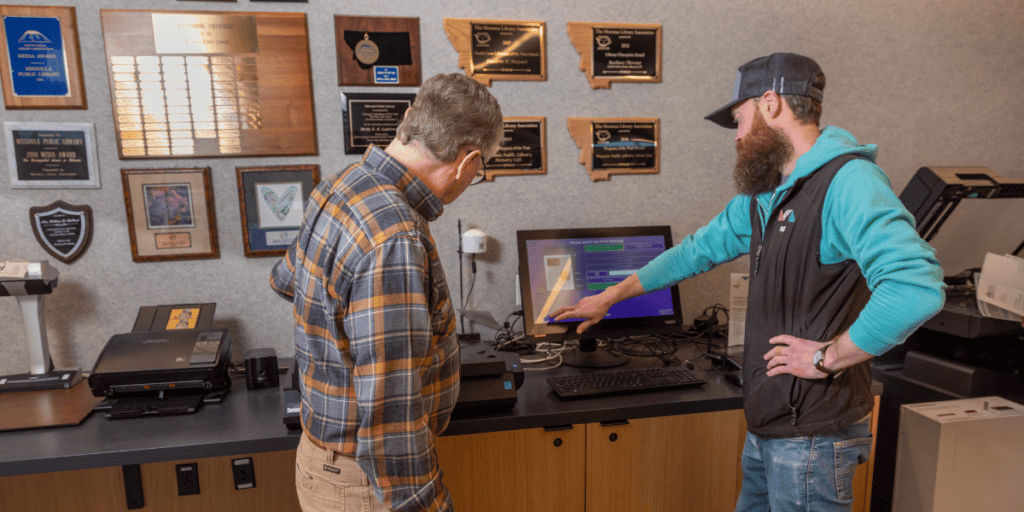 Staff instructing patron about printing